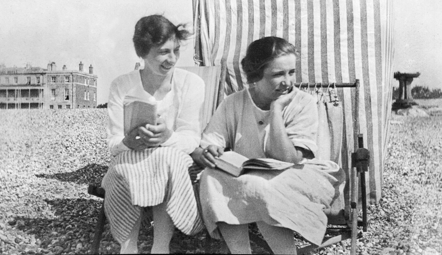 Goggie w Nanny reading on beach